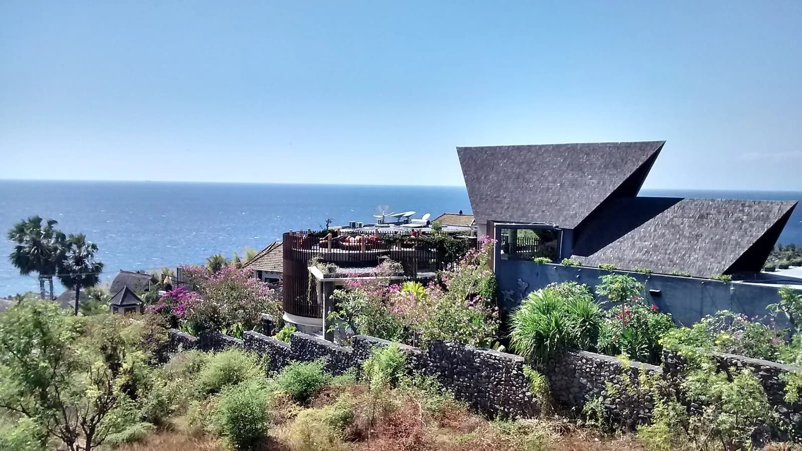 Clifftop villa with a sculpted shingle roof overlooking the sea in Bunutan, Amed, east Bali