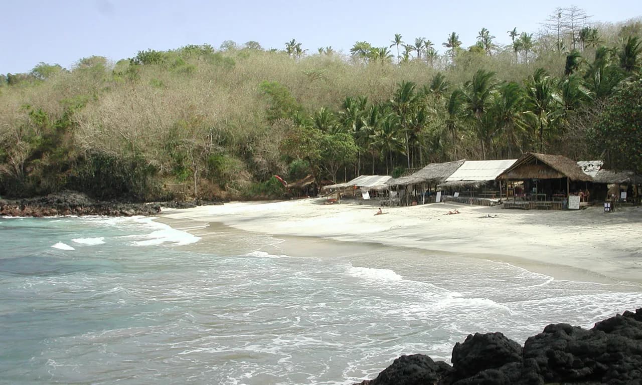 Bias Tugel Beach in Padang Bai, with warungs on the white sand and turquoise water, east Bali