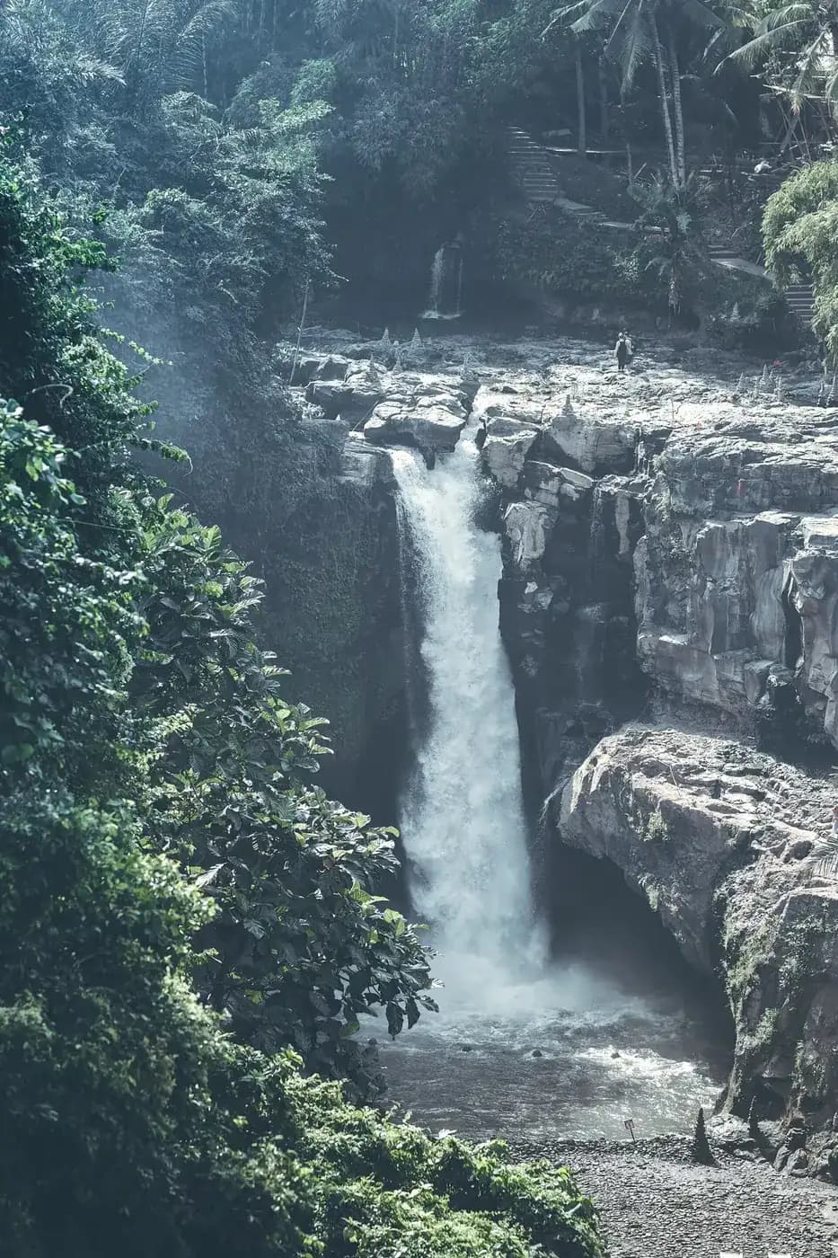 The Tegenungan gorge with the stepped path descending the hillside on the right towards the river