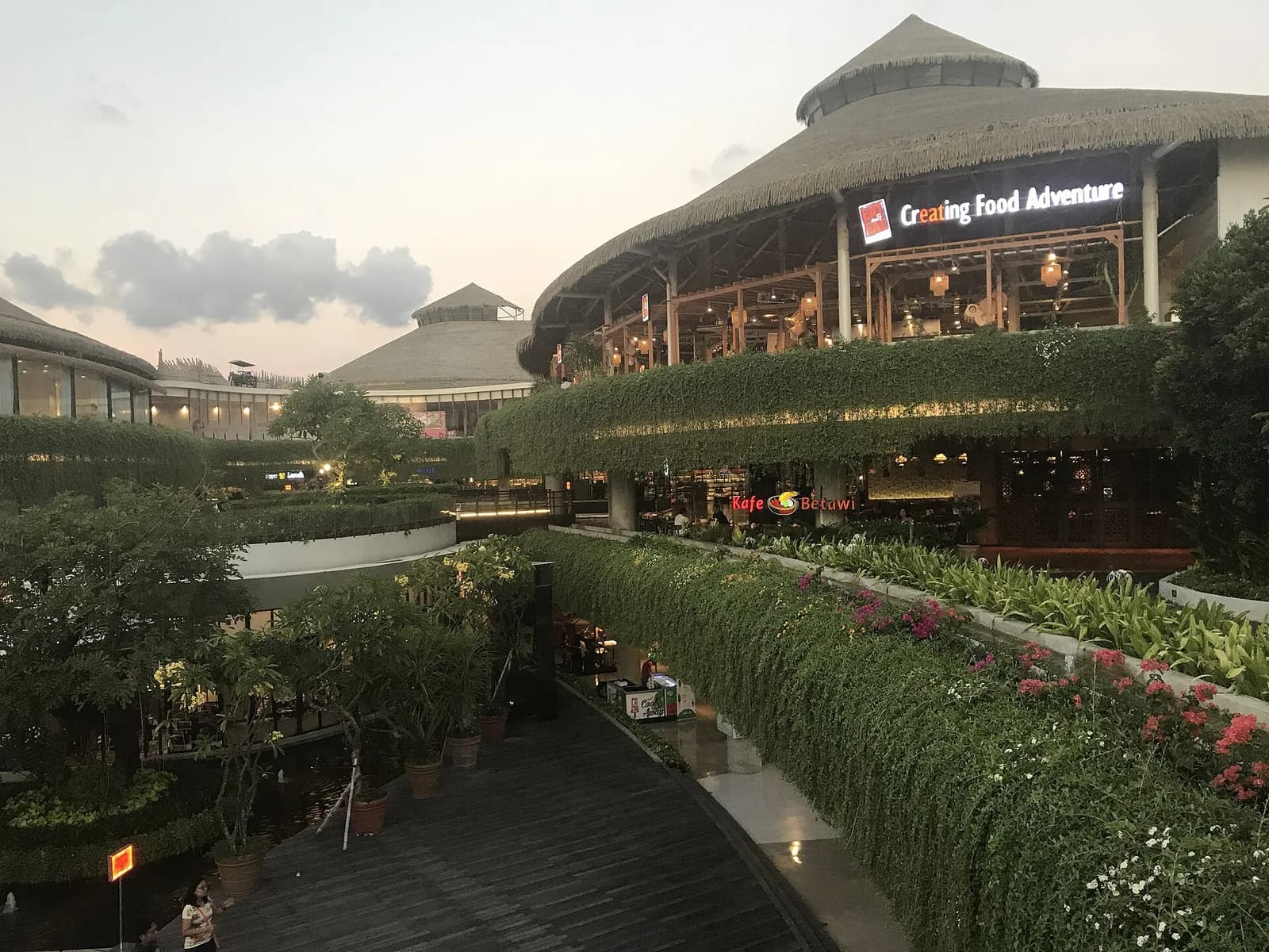 Thatched-roof dining pavilions and landscaped terraces at Beachwalk Shopping Center in Kuta, Bali