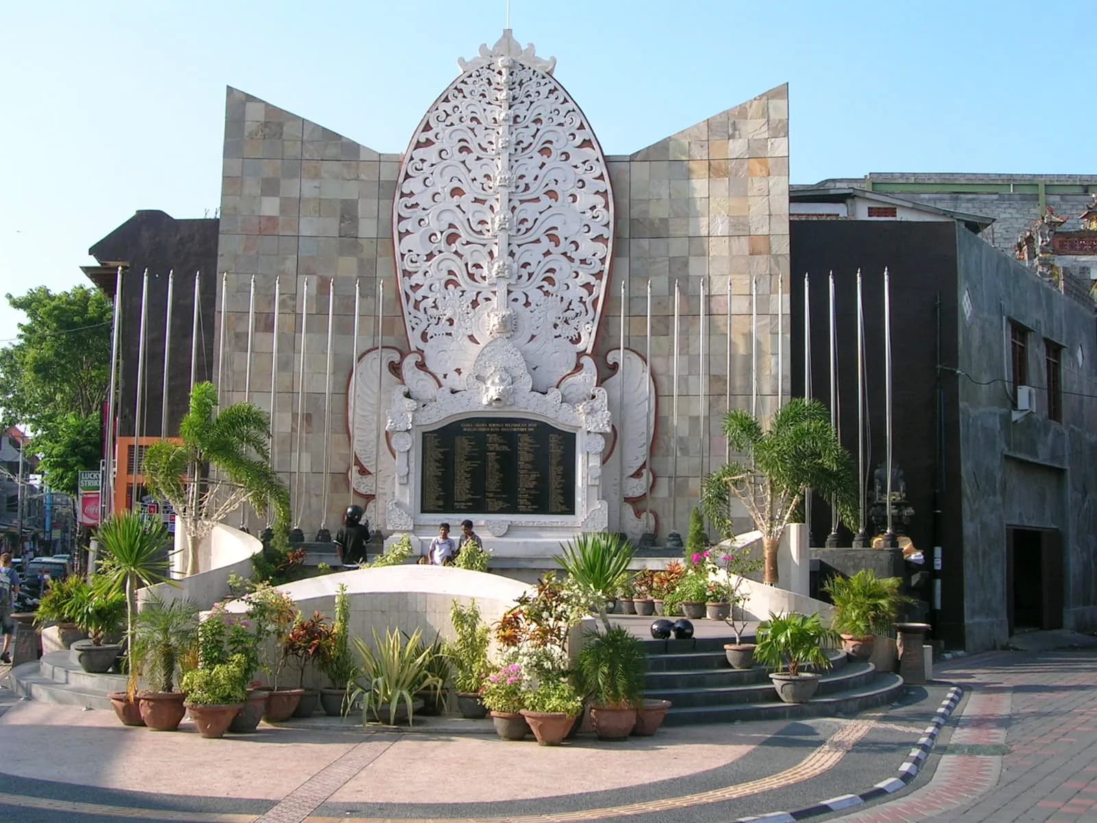 Bali Bombing Memorial on Jalan Legian in Kuta, a carved white stone monument with the victims' names on a black plaque