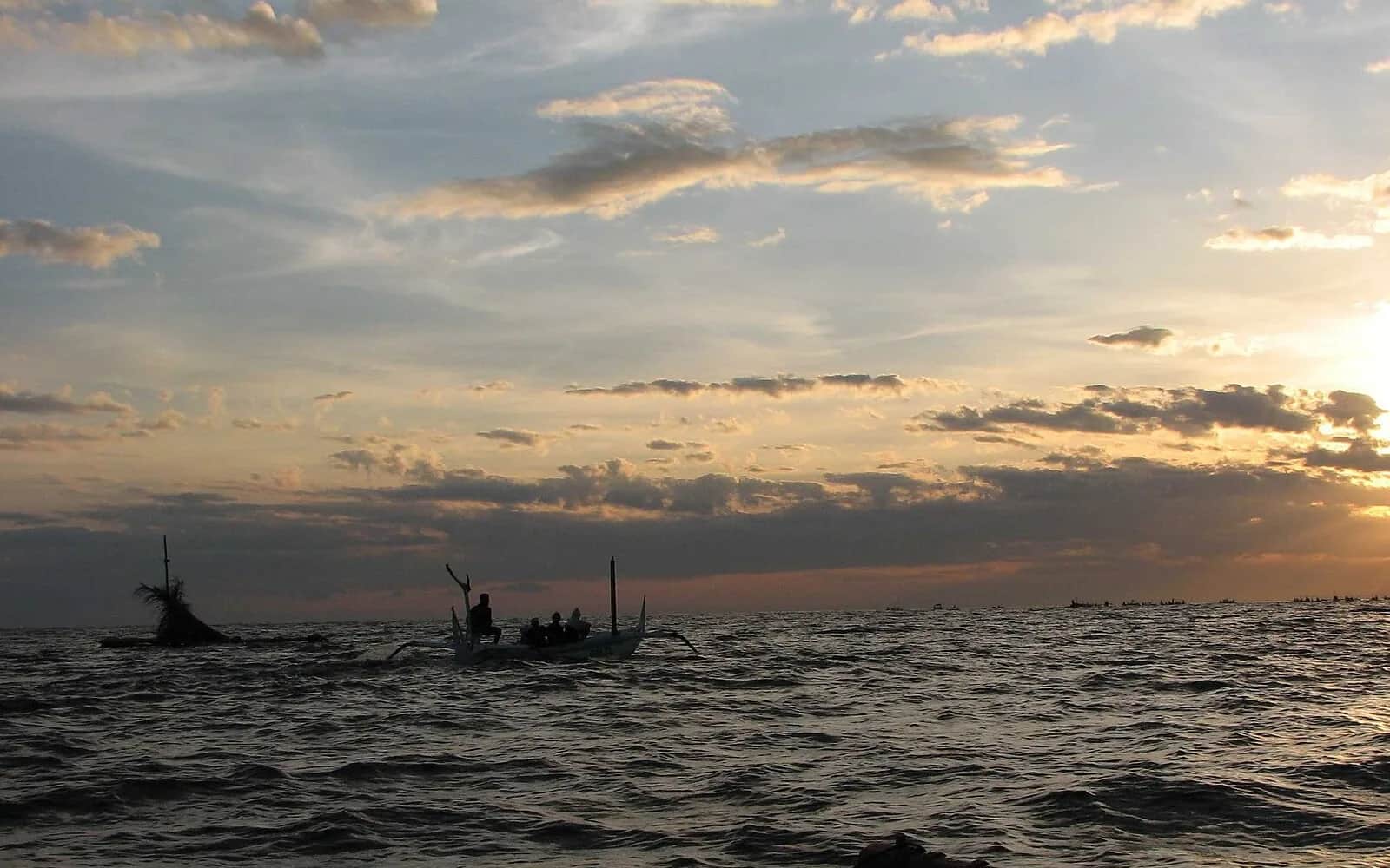 Traditional jukung outrigger boats on the sea off Lovina at sunrise, north Bali