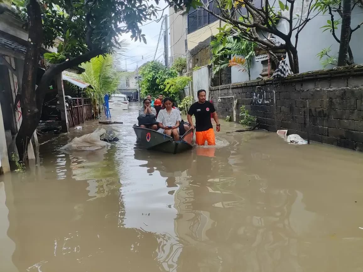 Residents evacuated by rescue boat along a flooded residential lane in Denpasar, Bali, during the September 2025 floods