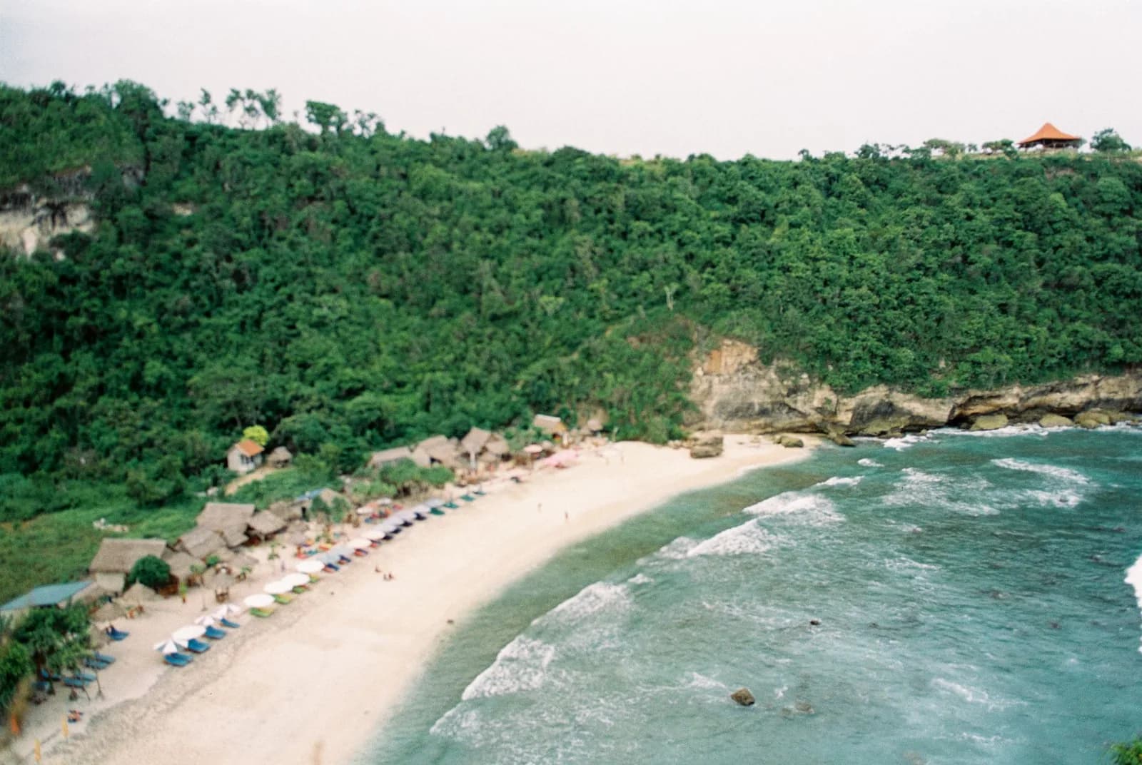 The row of warungs, loungers and umbrellas along the sand at Atuh Beach, Nusa Penida