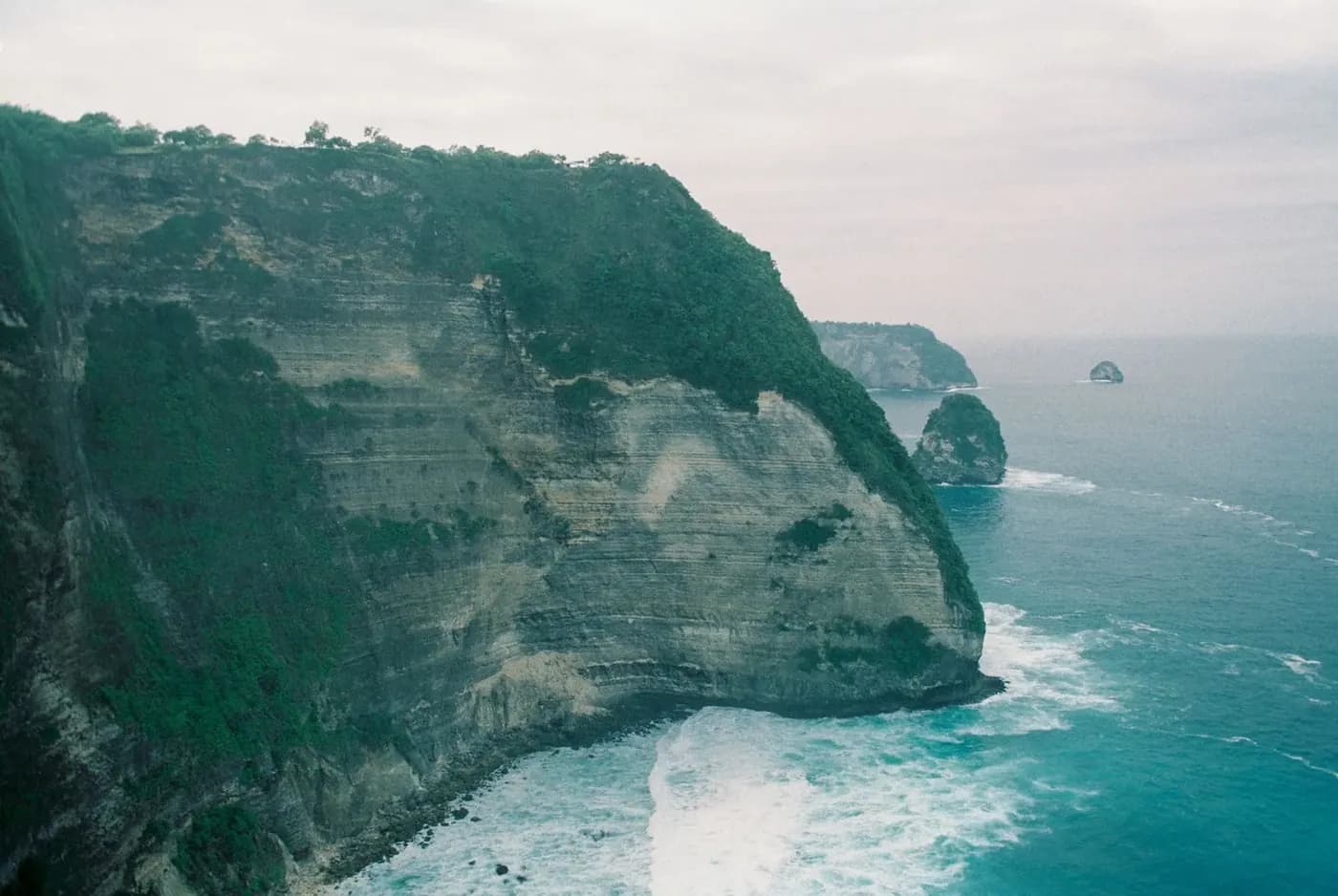 Limestone headland dropping into the sea on the west coast of Nusa Penida