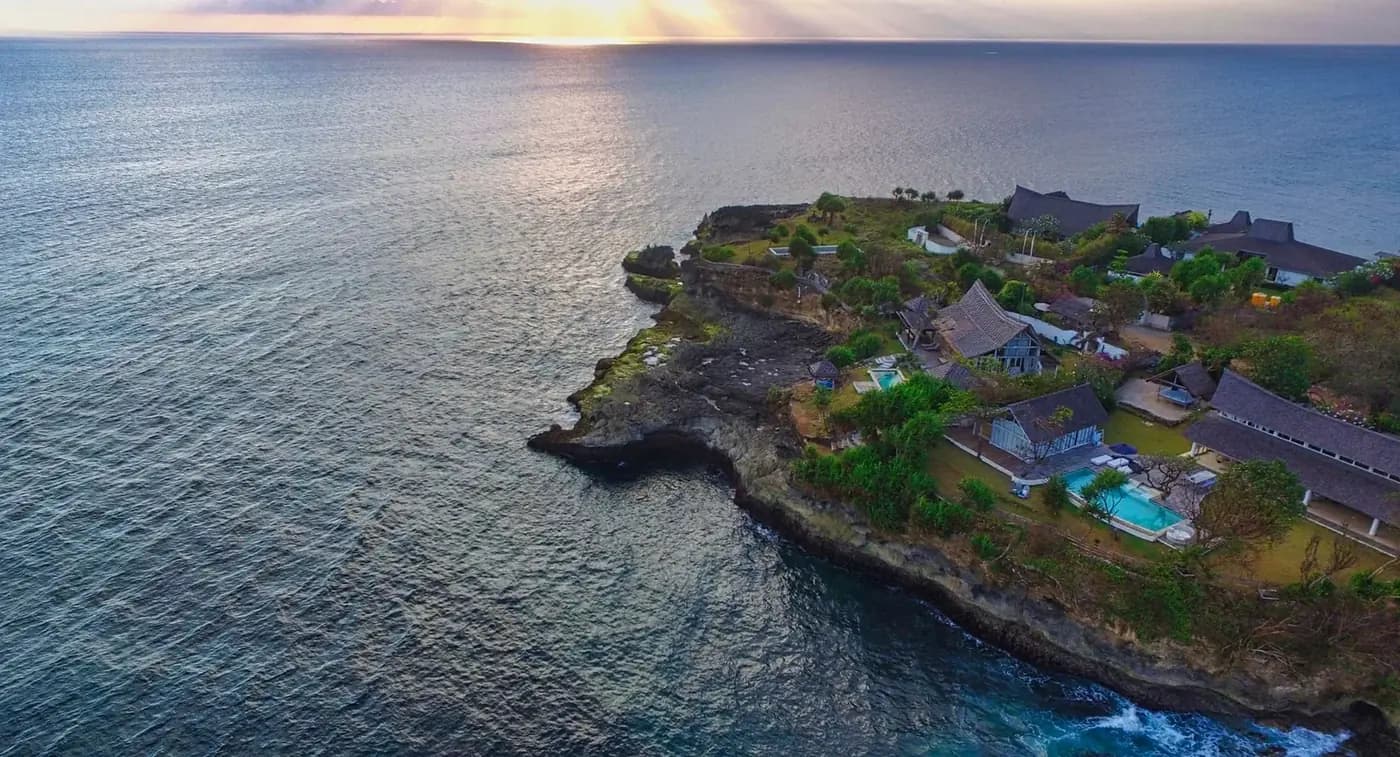 Clifftop villas above the sea at sunset in the Nusa islands, Bali