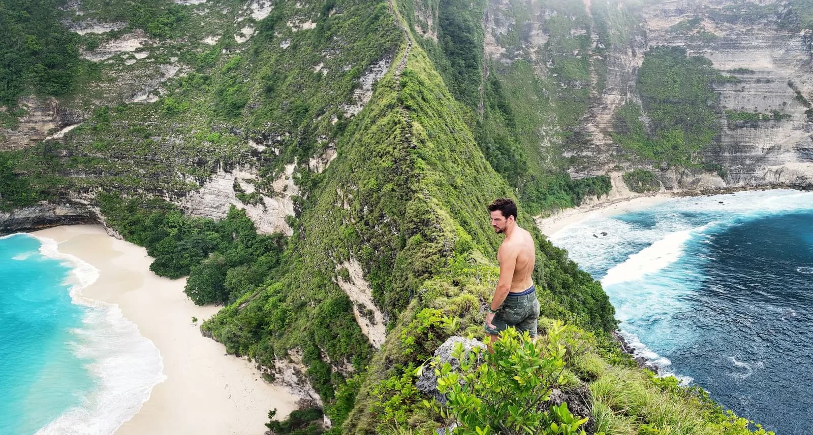 Walker on the Kelingking ridge above the descent path down to the bay, Nusa Penida