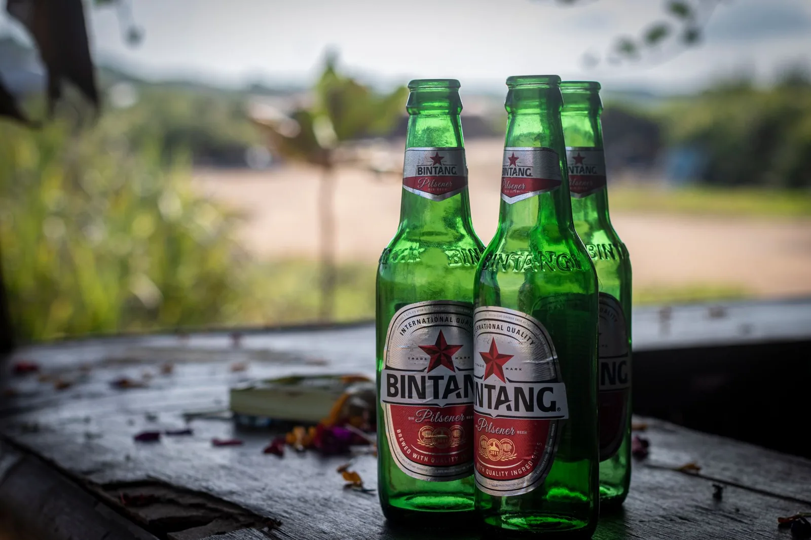 Bottles of Bintang beer on a wooden table in Bali