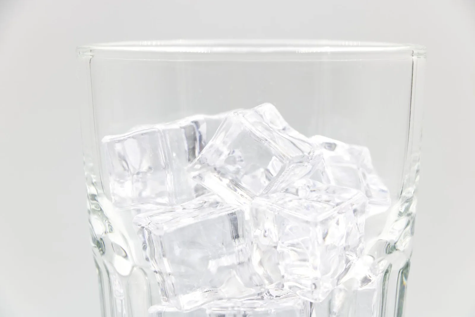 Close-up of ice cubes in a clear drinking glass