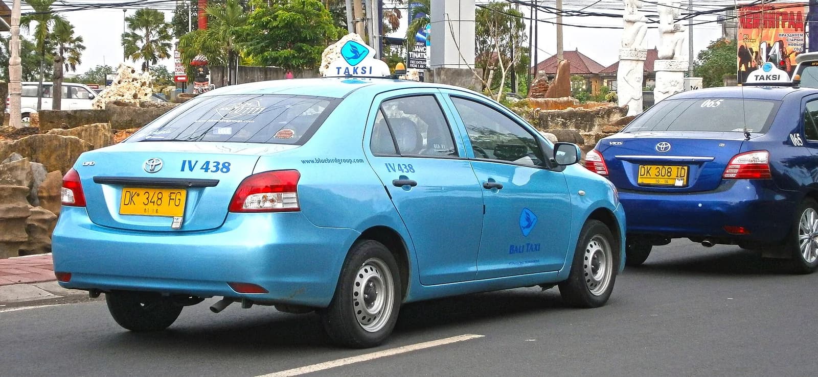 Light blue Blue Bird taxi on a street in Kuta, Bali