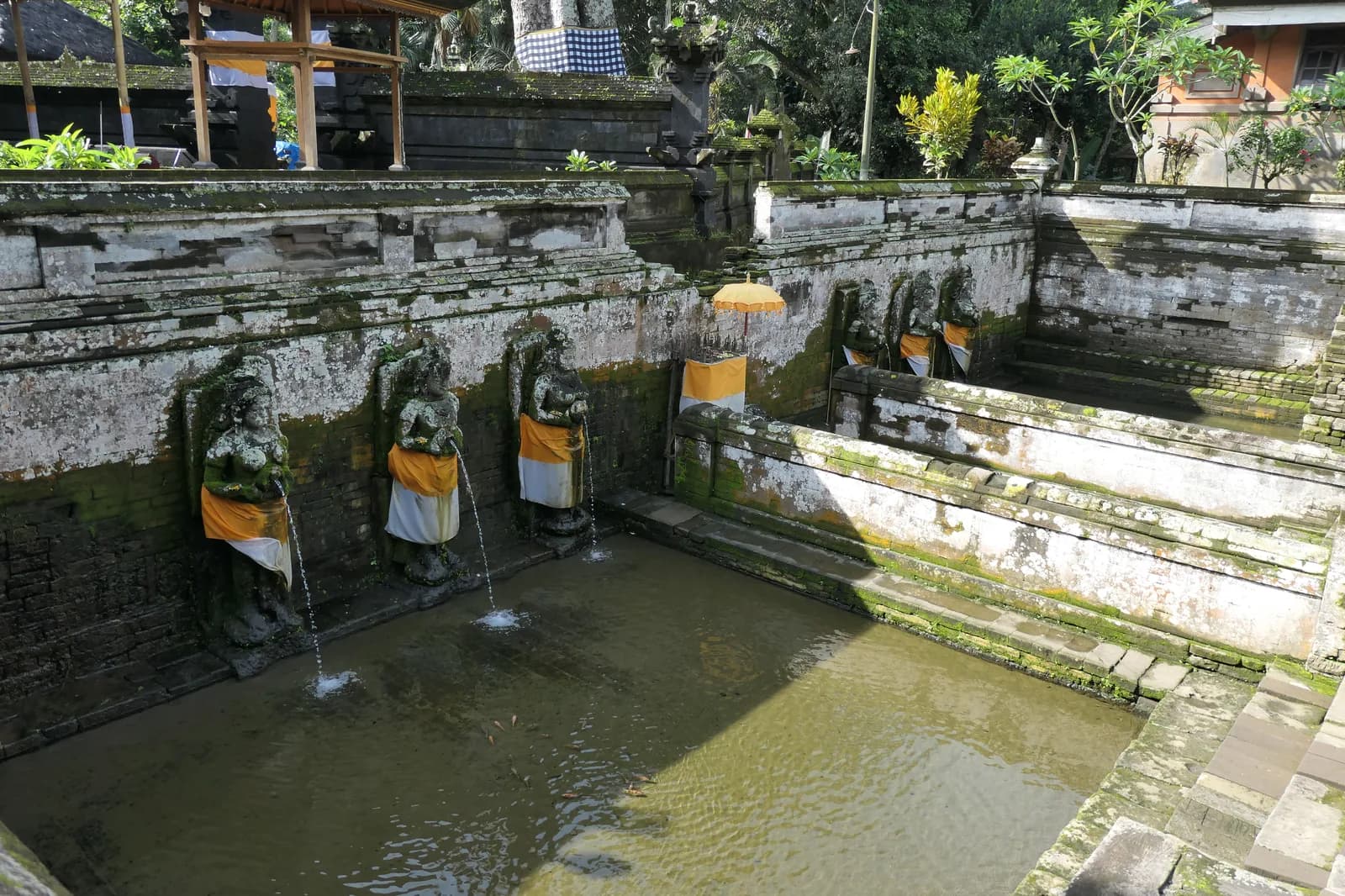 The excavated bathing pools at Goa Gajah with stone figures pouring water from pitchers, Bedulu, Bali