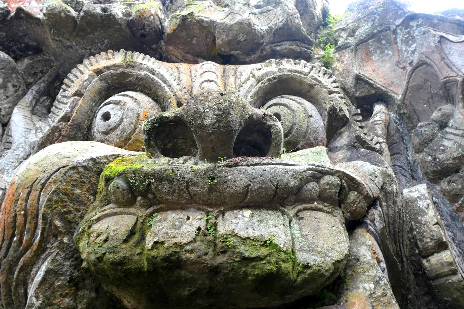 Close view of the carved Bhoma face above the cave entrance at Goa Gajah, Bedulu, Bali