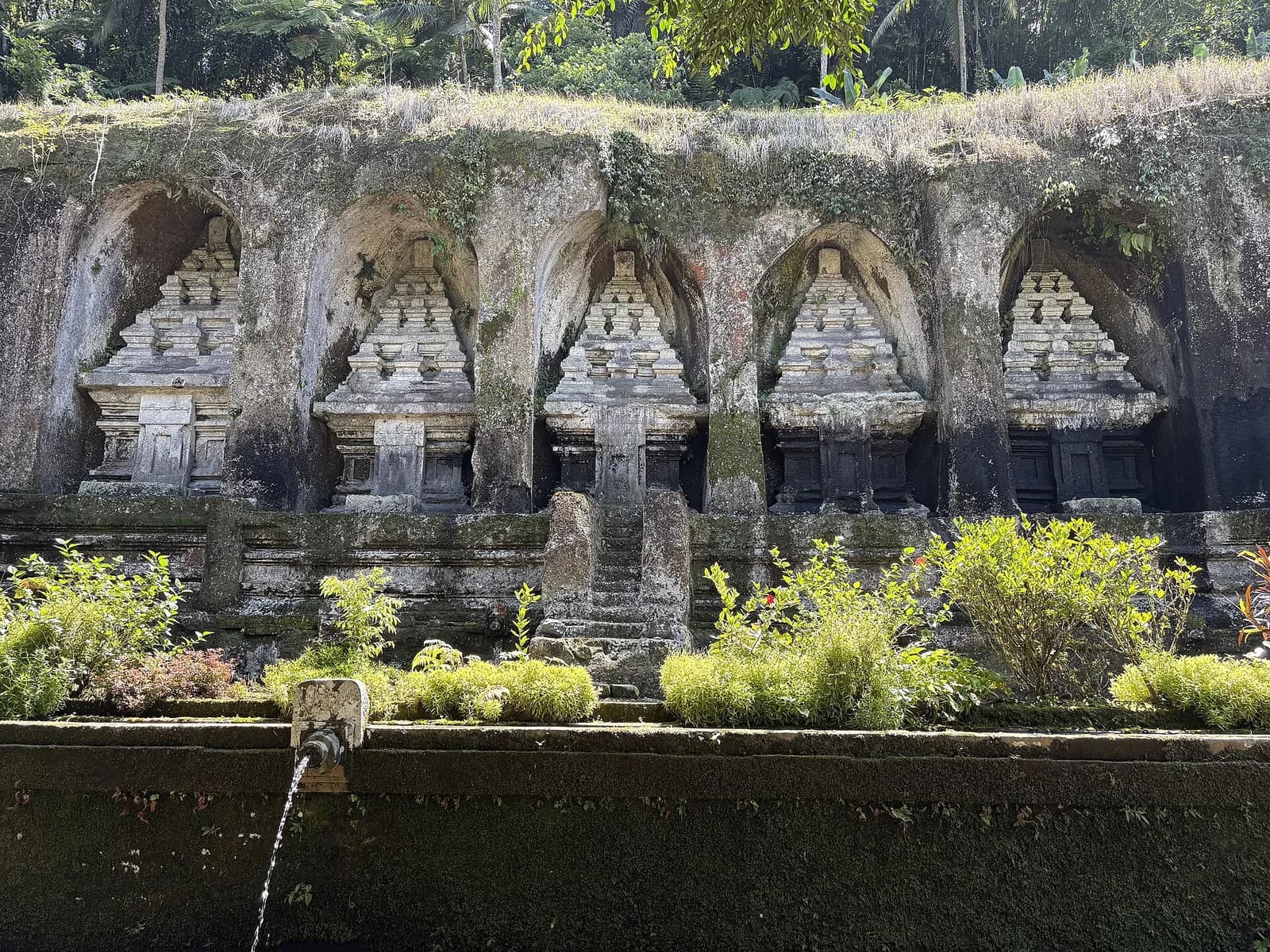 Row of five rock-cut candi shrines on the east bank of the Pakerisan river at Gunung Kawi, Tampaksiring, Bali