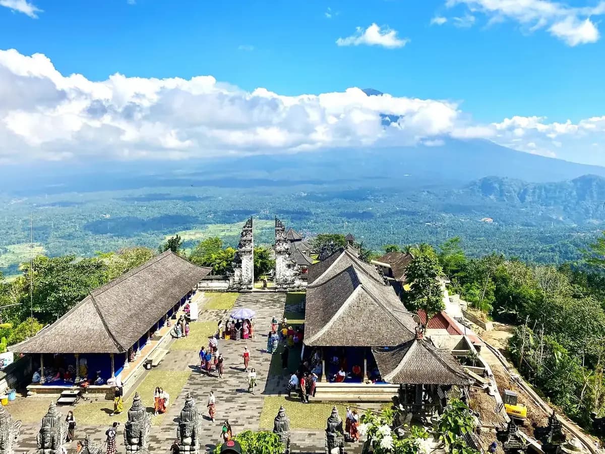 Elevated view over the Lempuyang courtyard with the split gate and Mount Agung behind it in cloud