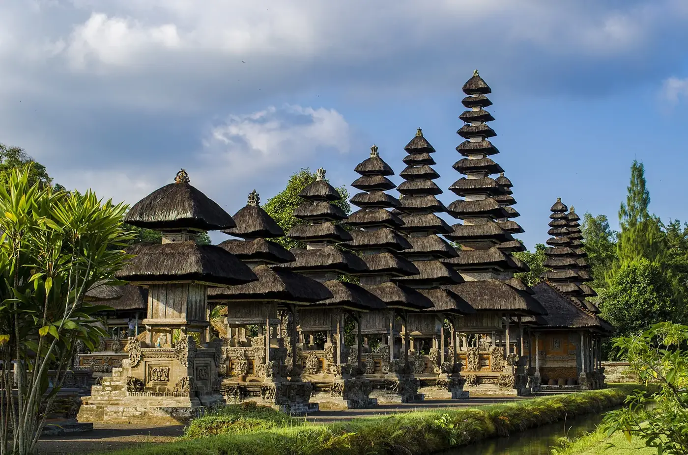 The line of thatched meru towers at Taman Ayun rising above the moat in morning light
