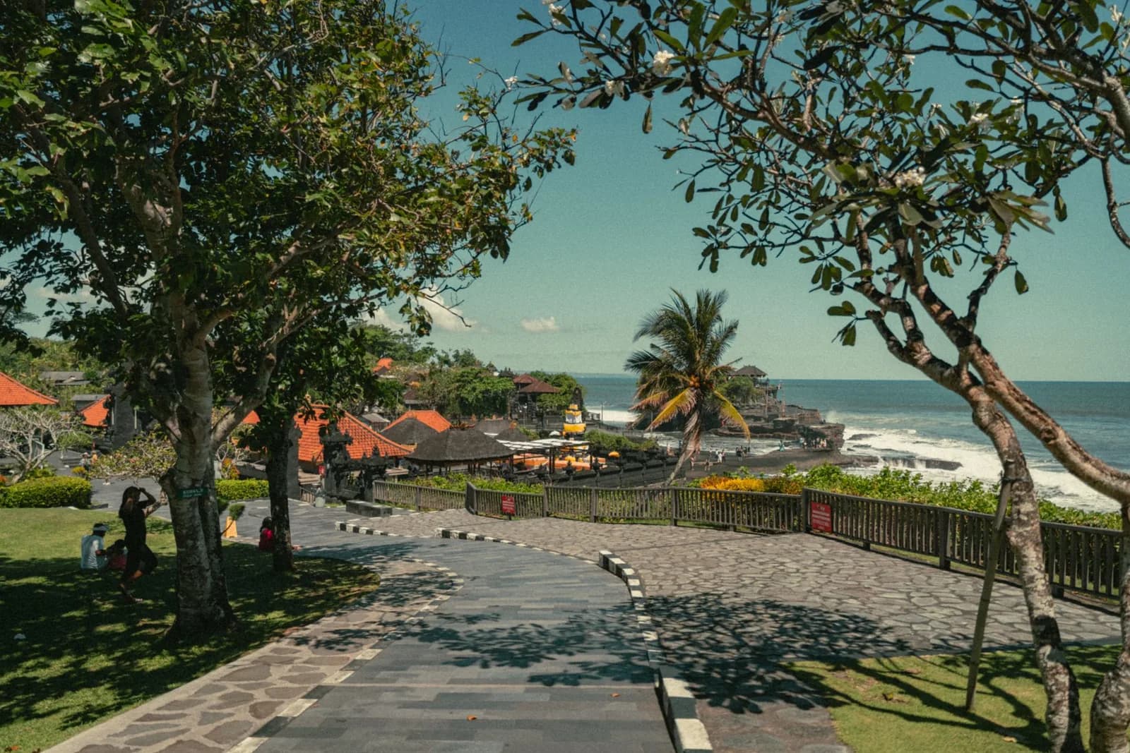 The paved walkway through the grounds at Tanah Lot leading towards the esplanade and the temple rock, Bali