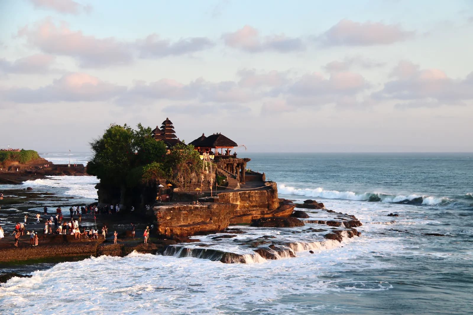 Tanah Lot temple on its rock above the surf at sunset, Bali