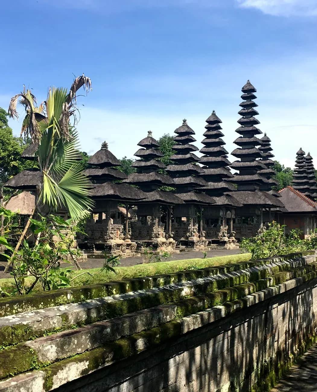 Row of meru towers at Taman Ayun temple seen across the moat wall, Mengwi, Bali
