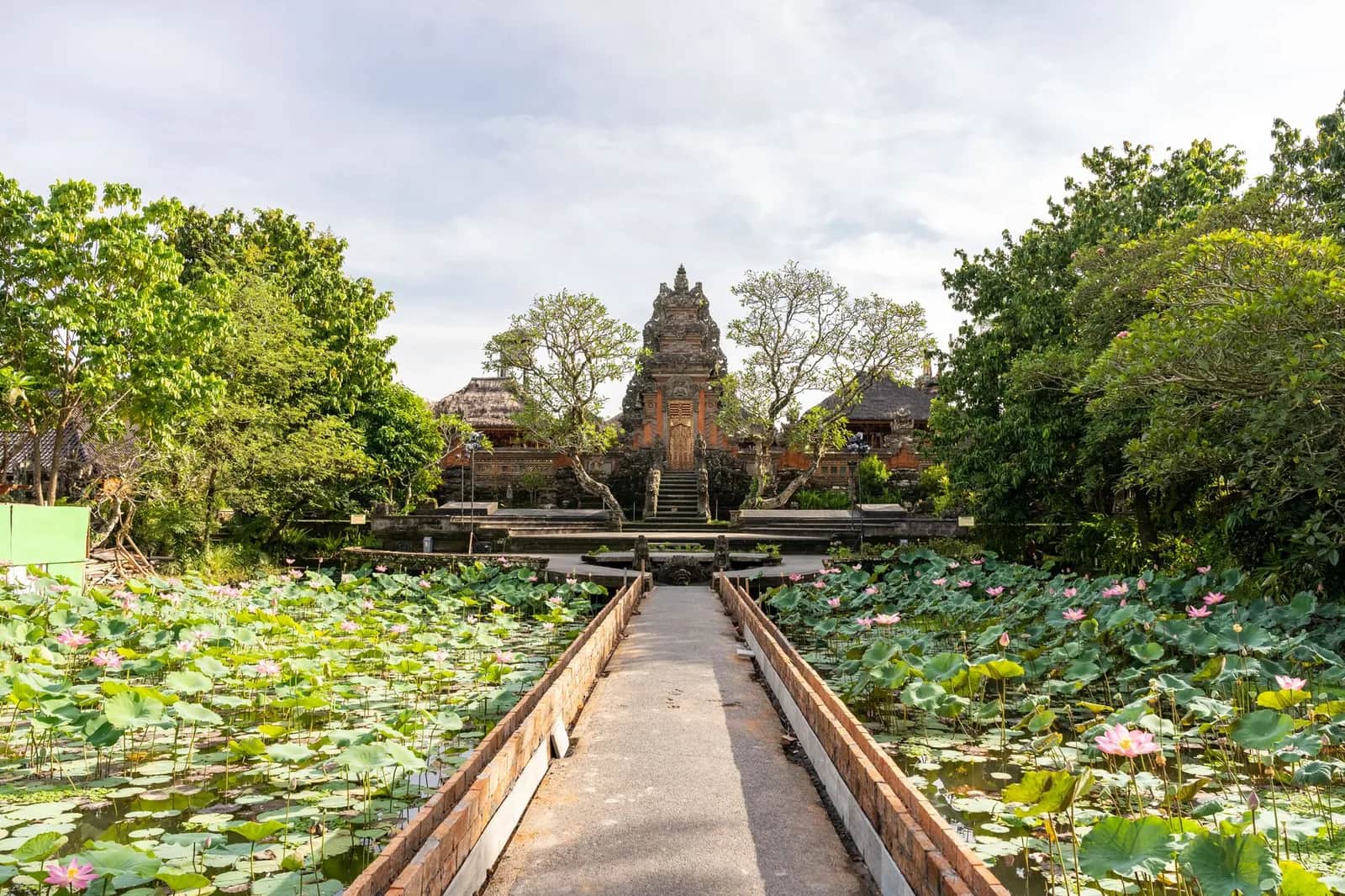 The stone path across the lotus pond to the temple gate at Pura Taman Saraswati, the Ubud Water Palace, Bali