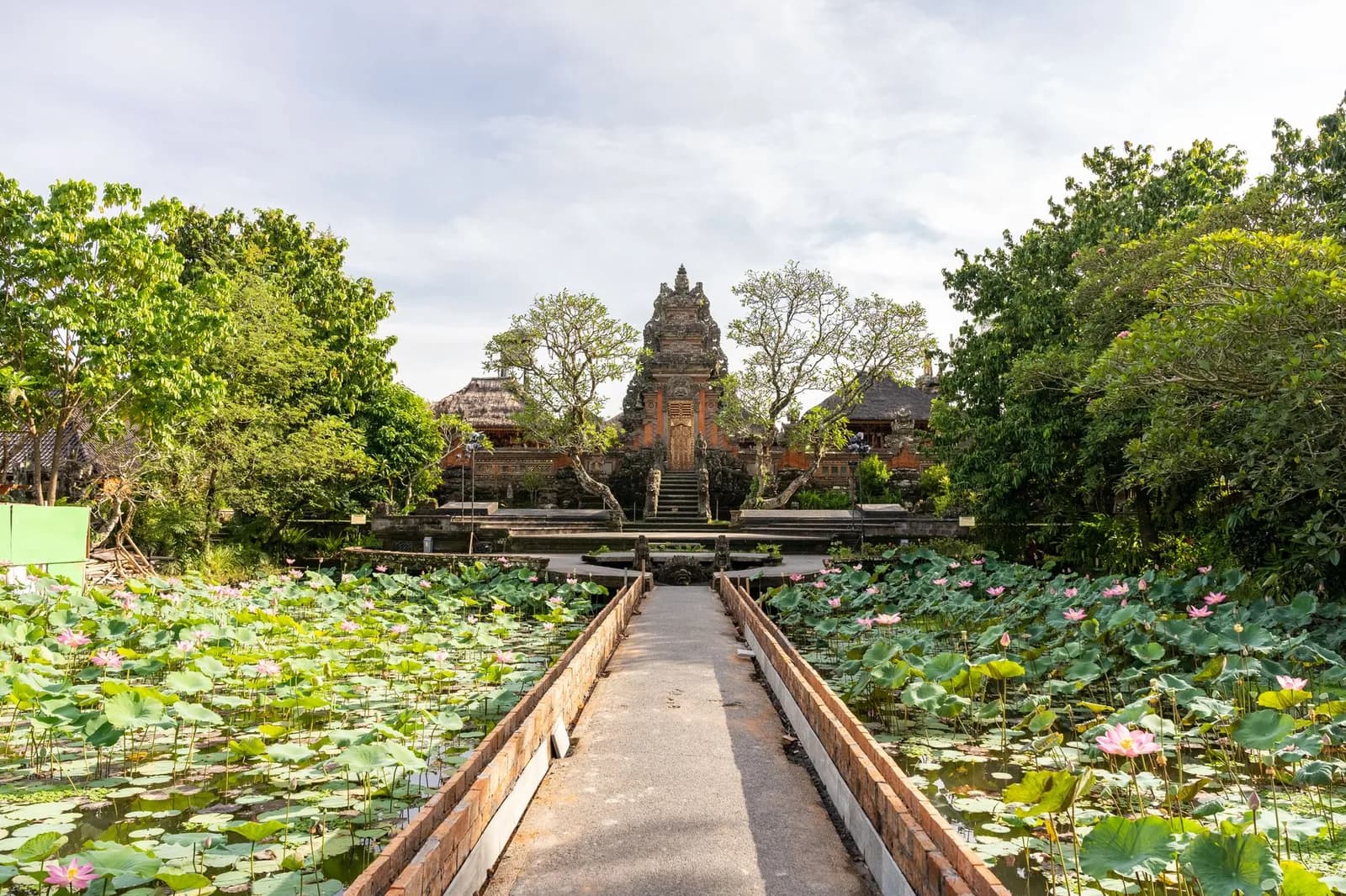 The stone path across the lotus pond to the temple gate at Pura Taman Saraswati, the Ubud Water Palace, Bali