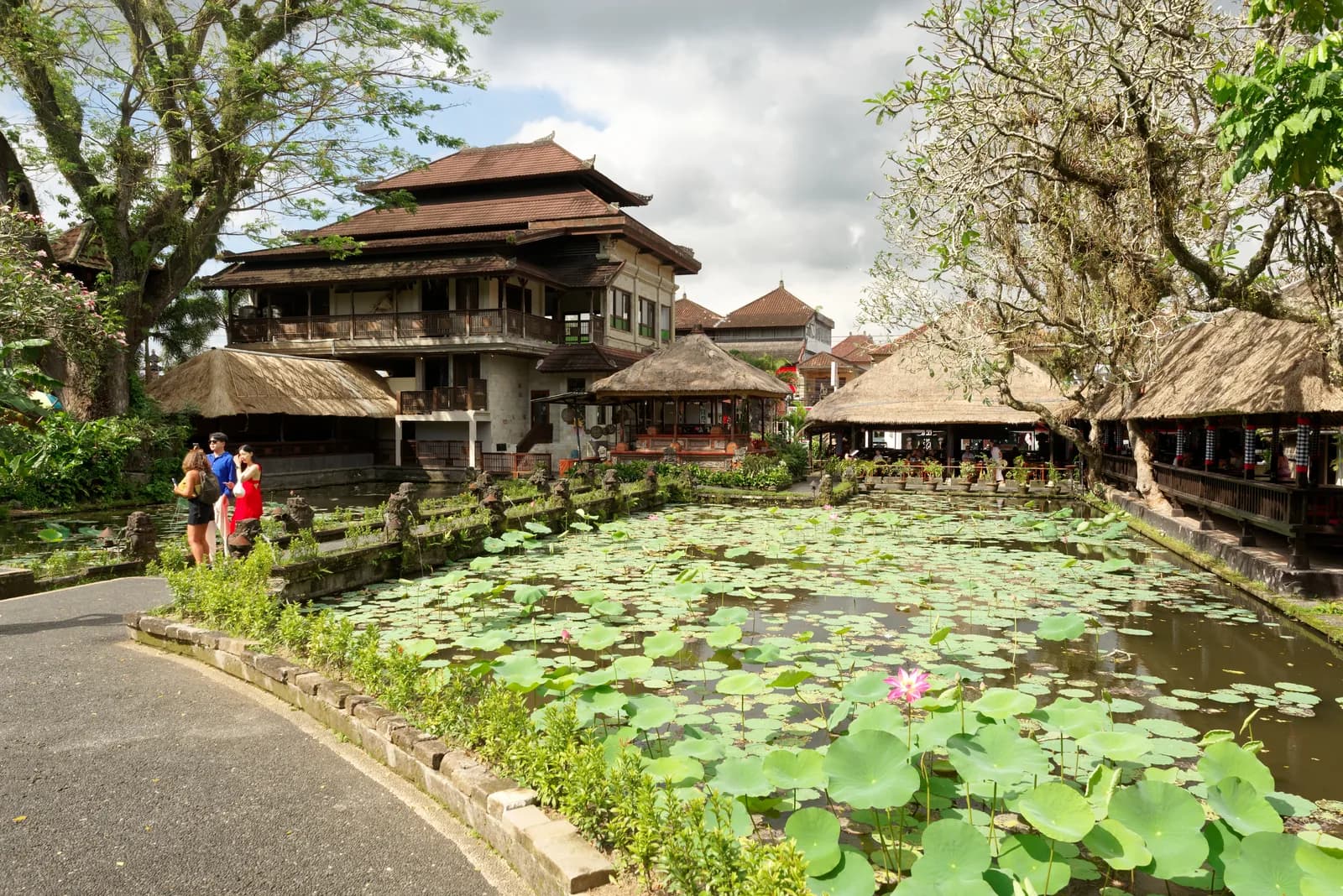 The thatched pavilions of Cafe Lotus along the lotus pond at the Ubud Water Palace, Bali