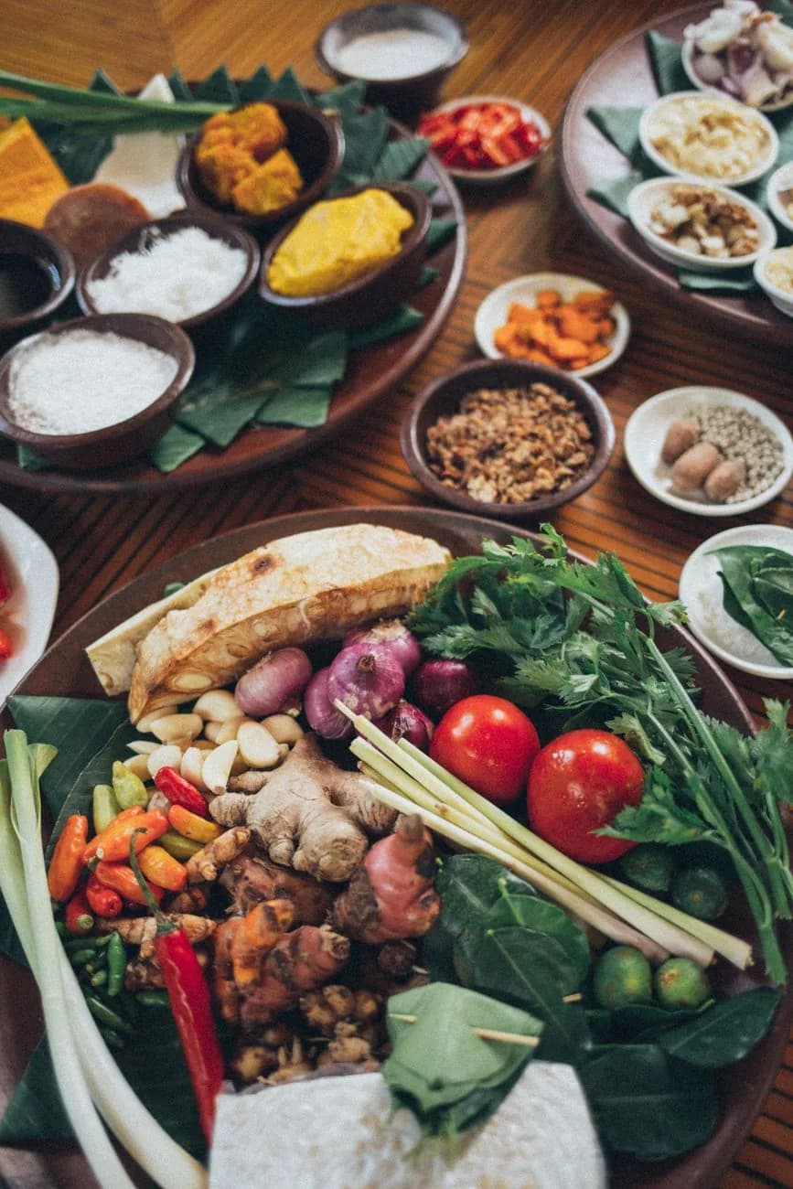 Trays of Balinese spices, shallots, chillies, lemongrass and turmeric laid out for a cooking class in Ubud