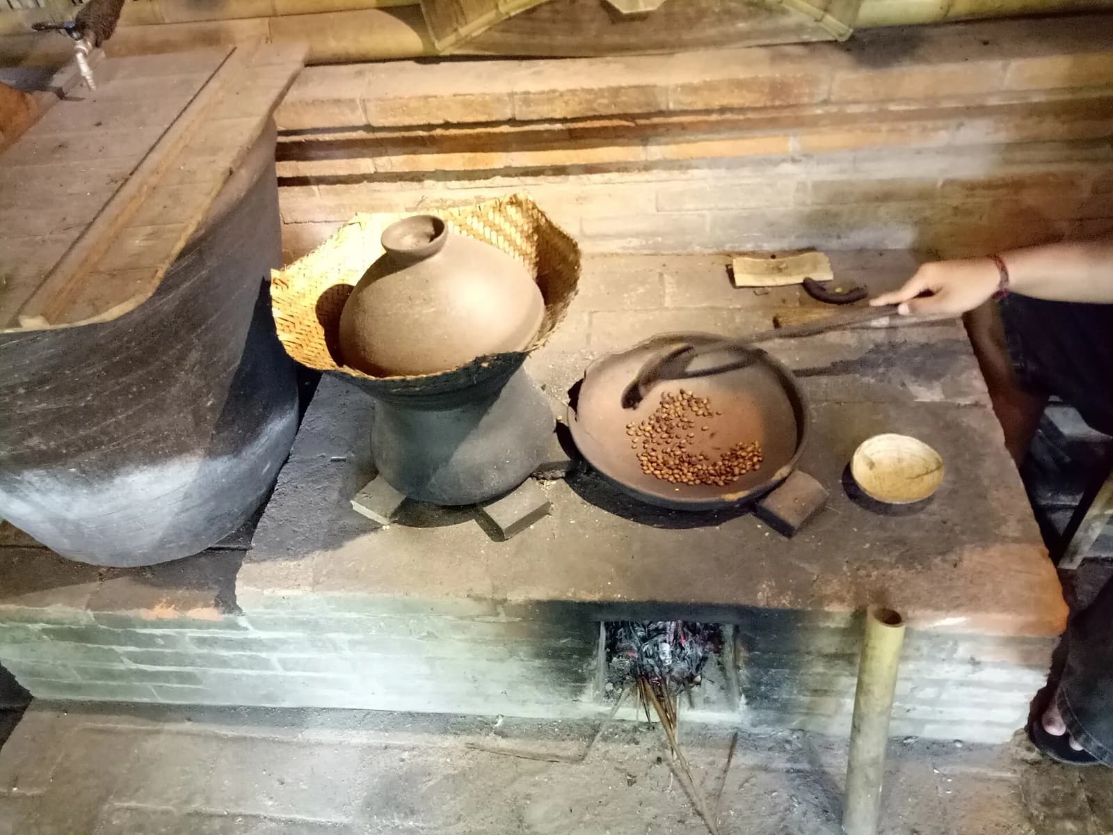 Coffee beans roasted by hand in a wok over a wood fire at a coffee plantation in Bali