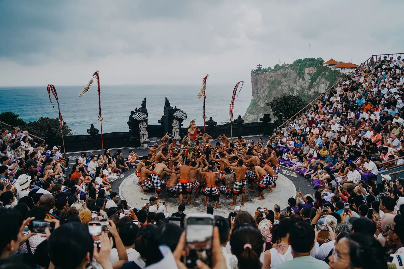 The full clifftop amphitheatre at Uluwatu, the chanting circle at its centre and the temple on the headland behind