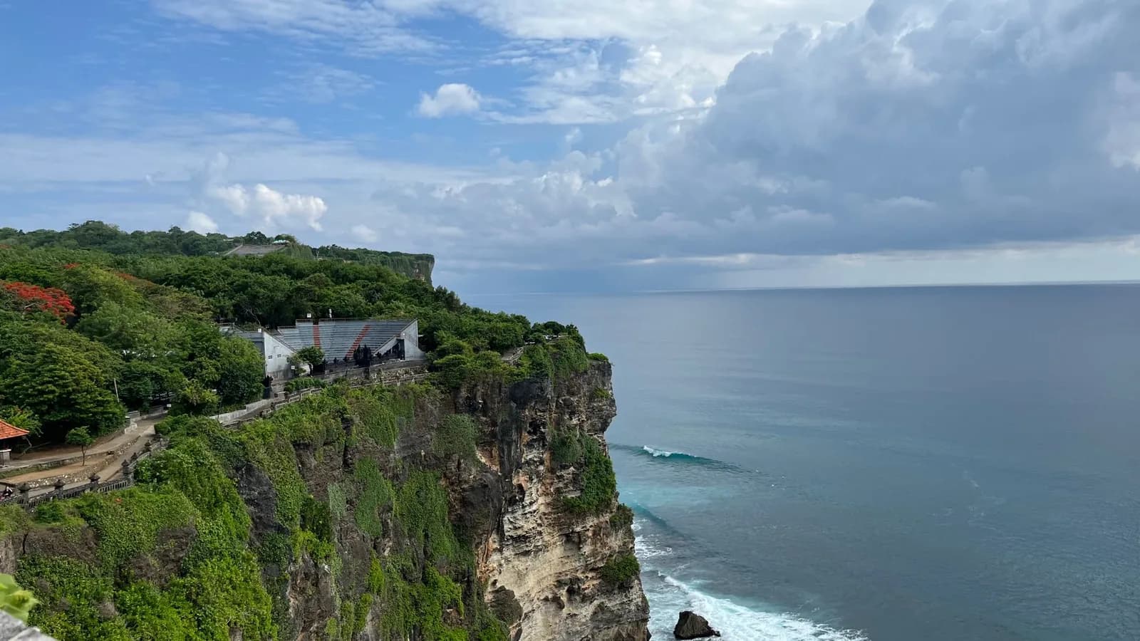 The clifftop at Uluwatu in the middle of the day, with the kecak amphitheatre and the temple path along the rim, Bali