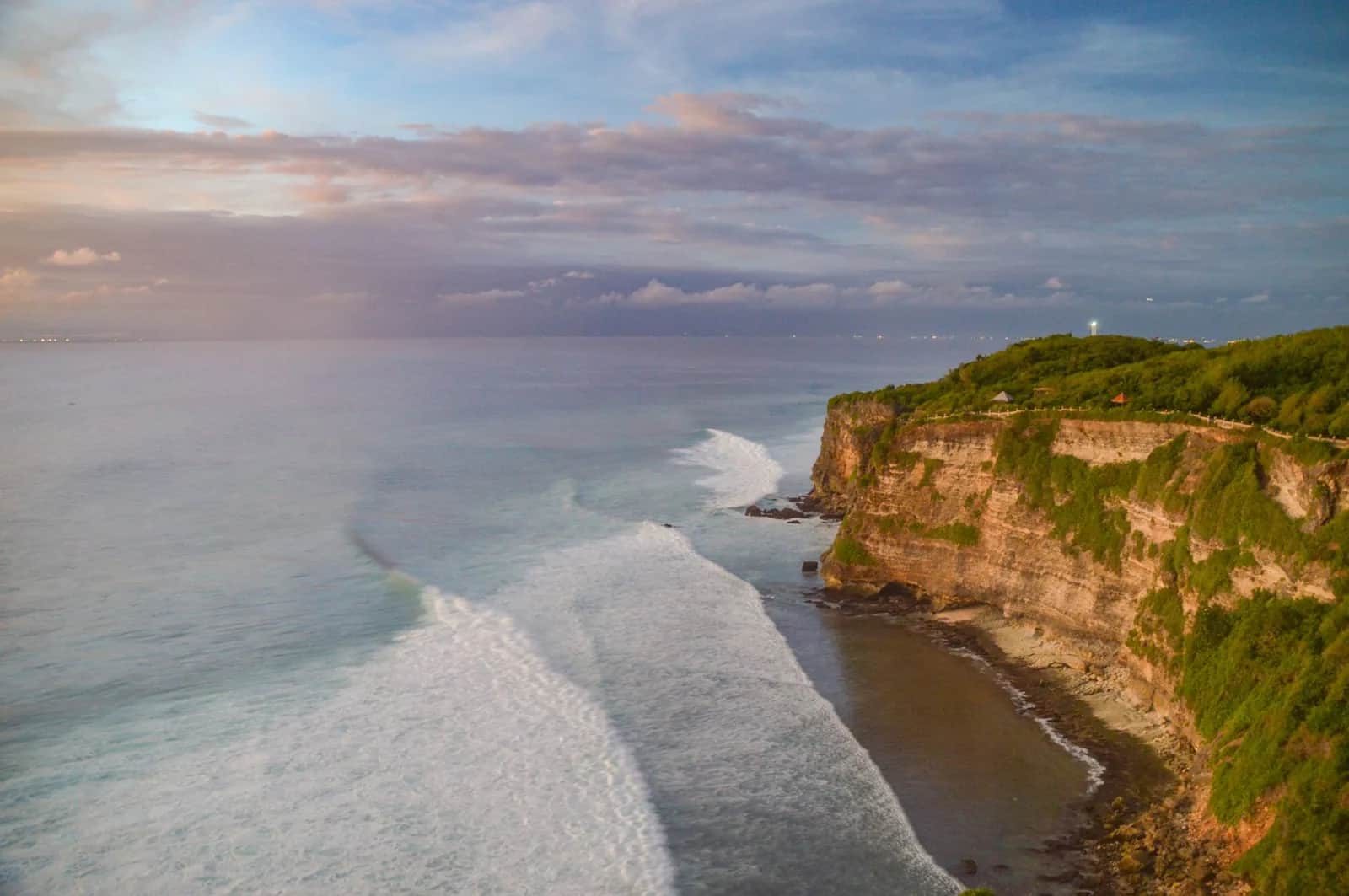 The limestone cliffs of the Bukit peninsula at Uluwatu, Bali, with surf breaking along the reef below