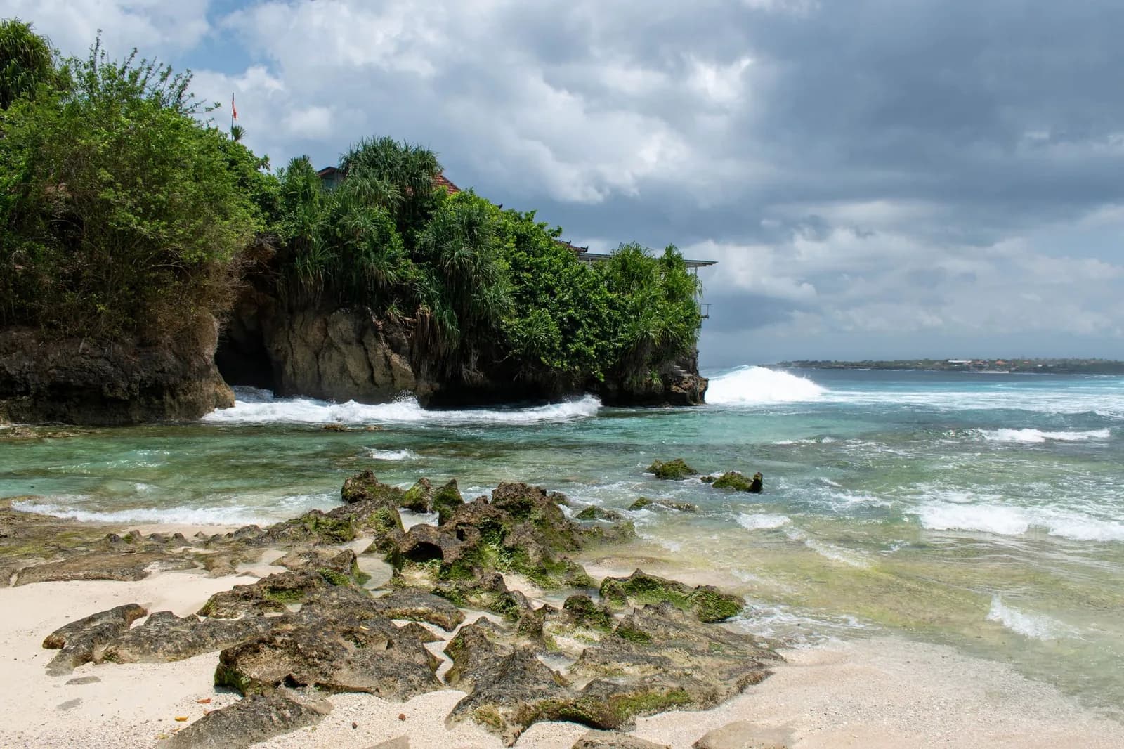 Exposed coral reef on the shoreline of a Bukit peninsula beach in Bali at low tide